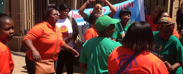 Members of the Diepsloot Early Childhood Development Forum sing outside court after sentencing was handed on 29 October 2014. Picture: Reinart Toerien/EWN.