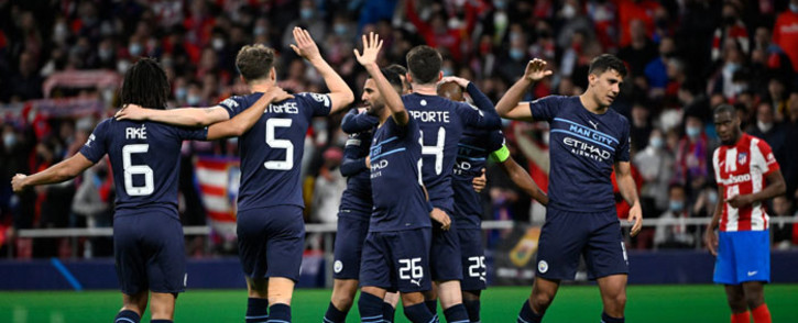Manchester City players celebrate at the end of the Uefa Champions League quarterfinal second leg football match between Club Atletico de Madrid and Manchester City FC at the Wanda Metropolitano stadium in Madrid on 13 April 2022. Picture: Pierre-Philippe MARCOU/AFP