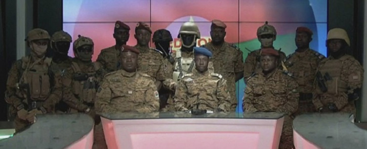 This video grab taken from a video obtained by AFPTV from Radio Télévision du Burkina (RTB) on January 24, 2022 shows Captain Sidsoré Kader Ouedraogo (C), spokesman for the junta, with uniformed soldiers announcing on television that they have taken power and 'put an end to the power' of Burkina Faso's President Roch Marc Christian Kaboré, in Ouagadougou. Soldiers in Burkina Faso on January 24, 2022 announced on state television that they have seized power in the West African country following a mutiny over the civilian president's failure to contain an Islamist insurgency. Picture: Radio Télévision du Burkina (RTB) / AFP
