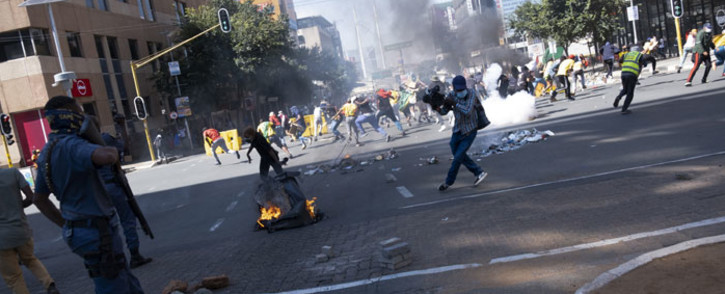 South African Police Service (SAPS) officers use teargas to disperse students during a protest in Braamfontein, Johannesburg, on March 10, 2021. Picture: Emmanuel Croset/AFP