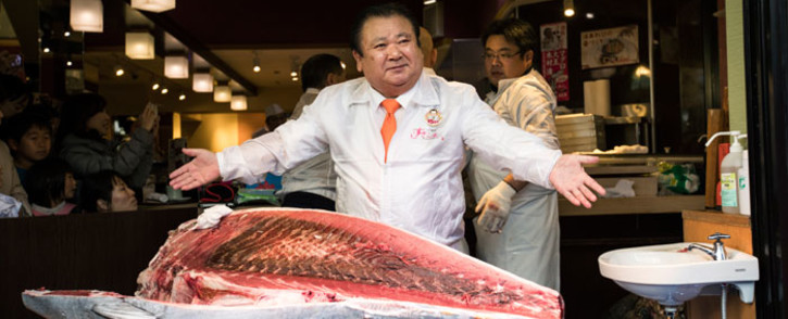 Kiyoshi Kimura, president of sushi restaurant chain Sushizanmai, poses with a 212kg bluefin tuna at his main restaurant near the Tsukiji fish market in Tokyo. Picture: AFP.