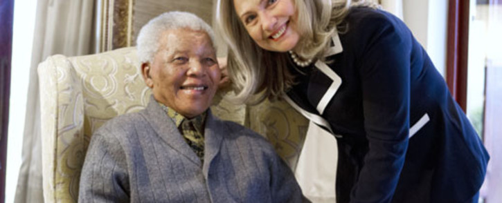 US Secretary of State Hillary Clinton stands next to a Mr Nelson Mandela statue.