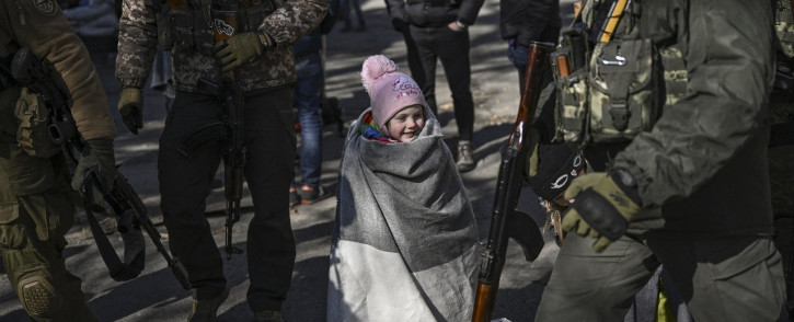 A child wait to be evacuated from the city of Irpin, north of Kyiv, on 10 March 2022.