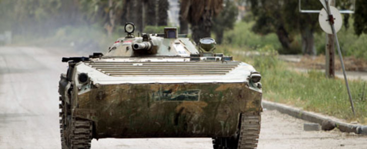 A Syrian army tank patrols an area in the district of Al-Waar in the flashpoint city of Homs. Picture: AFP