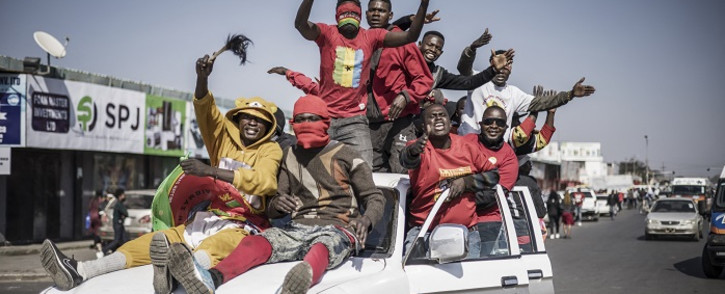 Supporters of Zambian President elect for the opposition party United Party for National Development (UPND) Hakainde Hichilema gestures as they ride on a pick up truck in the streets of Lusaka on August 16, 2021. Picture: Marco Longari / AFP.