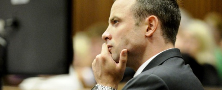 FILE: Oscar Pistorius watches proceedings during the first day of his murder trial on 3 March 2014. Picture: Pool.