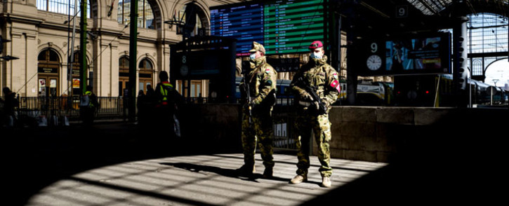 FILE: Hungarian soldiers stand on guard wearing protective masks in front of the Keleti (Eastern) railway station in Budapest, amid the spread of the novel coronavirus COVID-19 pandemic on 24 March 2020. Picture: AFP
