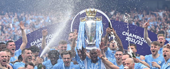 Manchester City midfielder Fernandinho lifts the Premier League trophy as City players celebrate on the pitch after the English Premier League football match between Manchester City and Aston Villa at the Etihad Stadium in Manchester, north west England, on 22 May 2022. Picture: Oli SCARFF/AFP