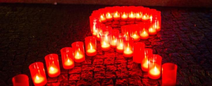 Candles form a red ribbon during World Aids Day. Picture: AFP. 