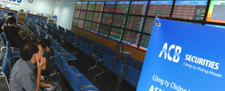 Investors sit watching share prices at an Asia Commercial Bank (ACB)'s securities trading floor in Hanoi on August 22, 2012. Picture: AFP.
