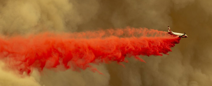 A Coulson 737 firefighting tanker jet drops fire retardant to slow Bobcat Fire at the top of a major run up a mountainside in the Angeles National Forest on 10 September 2020 north of Monrovia, California. Picture: AFP