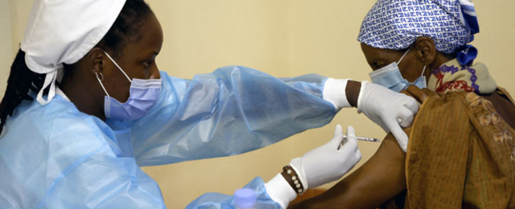 FILE: A medical worker injects a second dose of AstraZeneca vaccine to a patient in a COVID-19 vaccination centre in Kigali, Rwanda, on 27 May 2021. Picture: Ludovic MARIN/AFP