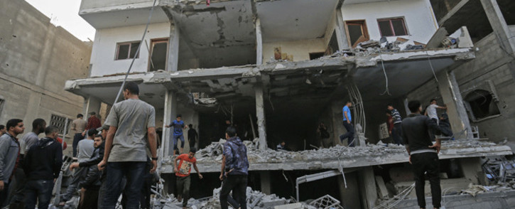 Palestinians check the damage in a building targeted by Israeli airstrikes on Rafah in the southern Gaza Strip on 5 May, 2019. Picture: AFP.