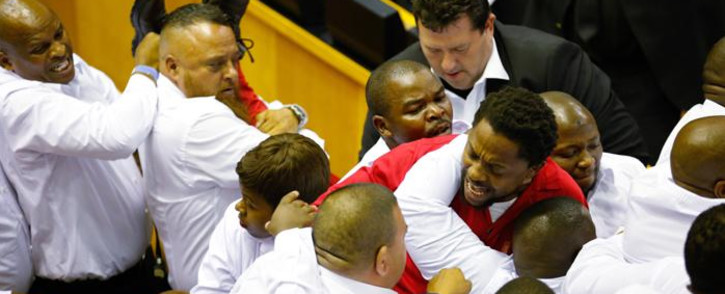Security officials remove the EFF's Mbuyiseni Ndlozi from the National Assembly along with other party members after they disrupted President Zuma’s 2017 State of the Nation Address. Picture: AFP.