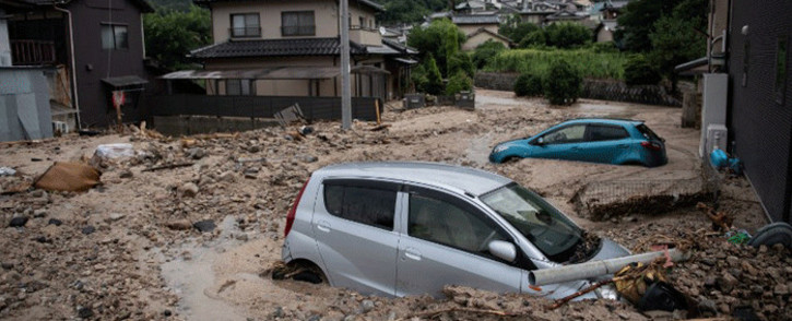 A picture shows cars trapped in the mud after floods in Saka, Hiroshima prefecture on 8 July, 2018. Picture: AFP.