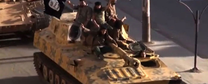 FILE:  A screen grab taken from a video released on 1 July,2014, allegedly shows members of ISIS parading on top of a tank on a street in the northern rebel-held Syrian city of Raqa.