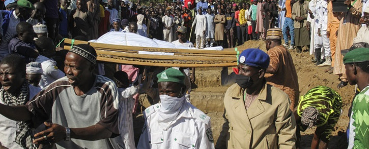FILE: Mourners attend the funeral of 43 farm workers in Zabarmari, about 20km from Maiduguri, Nigeria, on 29 November 2020 after they were killed by Boko Haram fighters in rice fields near the village of Koshobe on 28 November 2020. Picture: AFP
