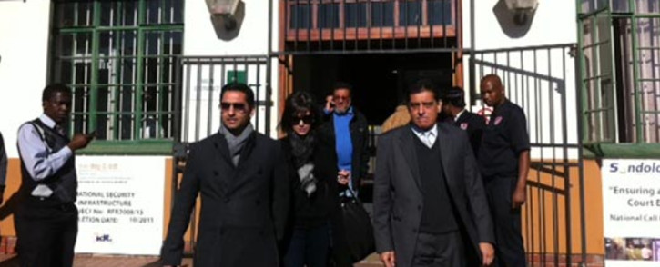Controversial Johannesburg businessman Zunaid Moti (L) leaves the Brits Regional Court with his wife (C) on 17 July, 2012. Picture: Rahima Essop/EWN