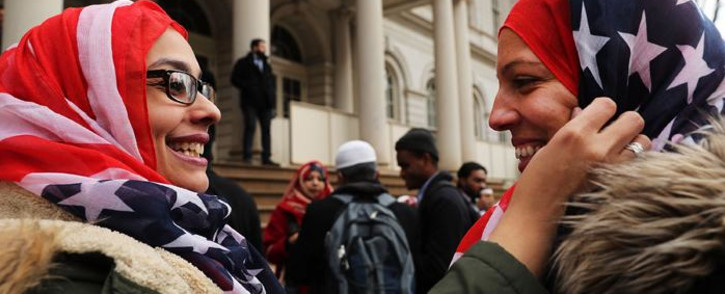 New York City police officers Aml Elsokary and Maritza Morales wear American flag headscarves at an event at City Hall for World Hijab Day on 1 February 2017 in New York City. Picture: AFP. 