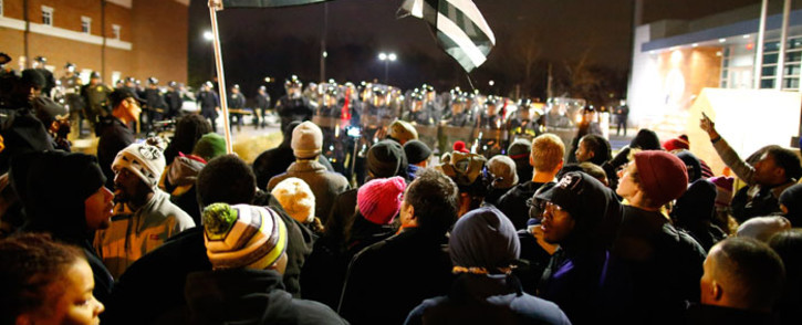 Protesters face a line of riot police in Ferguson, Missouri, on 24 November 2014. According to St Louis County Prosecuting Attorney, the Grand jury decided that Ferguson police Officer Darren Wilson will not be charged in the shooting death of unarmed teenager Michael Brown. Picture: EPA.