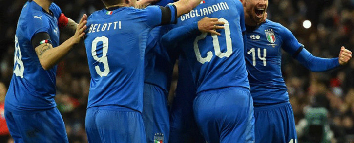 Italy's striker Lorenzo Insigne celebrates with teammates after scoring their first goal from the penalty spot during the International friendly football match between England and Italy at Wembley Stadium in London on 27 March, 2018. Picture: AFP