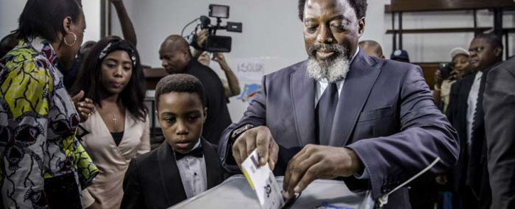 President of the Democratic Republic of Congo Joseph Kabila casts his vote along with his family at the Insititut de la Gombe polling station during general elections in Kinshasa on 30 December 2018. Picture: AFP