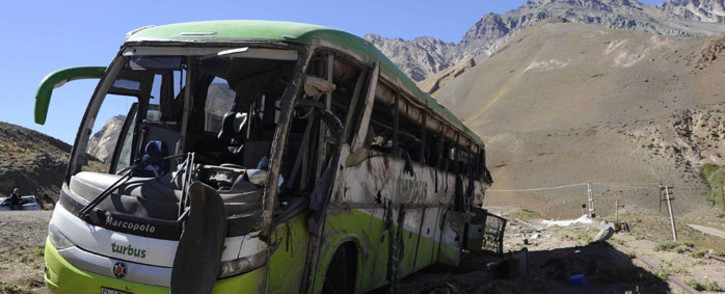 A view of the bus that overturned, leaving at least 19 of the 40 passengers dead and more than 20 injured, near the town of Uspallata in the western Argentine province of Mendoza on its way to Chile, early in the morning of February 18, 2017. Picture: AFP.