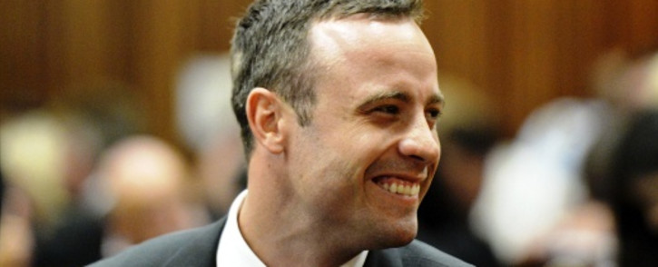 FILE: Oscar Pistorius smiles during the first day of his trial in the North Gauteng High Court on 3 March 2014. Picture: POOL.