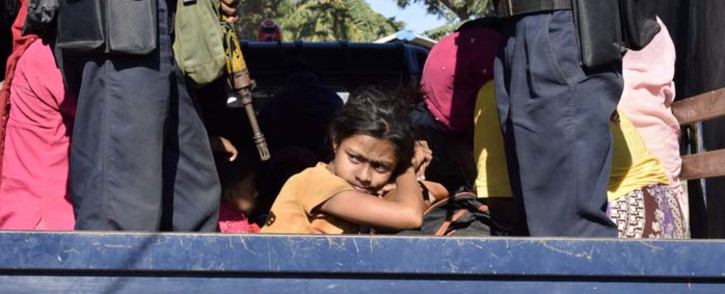 FILE: Myanmar police escort Rohingya Muslims back to their camp in Sittwe, Rakhine state, on 30 November 2018. Nearly 100 Rohingya Muslims were forced back to Myanmar's Rakhine state after being detained at sea en route to Malaysia, police said on 28 November, stirring fears of a fresh refugee boat crisis. Picture: AFP