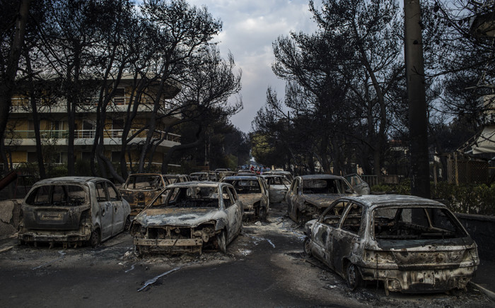 Burnt cars following a wildfire at the village of Mati, near Athens, on 24 July 2018. Picture: AFP
