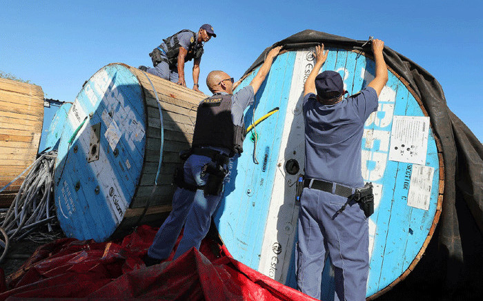 Cape Town police officers recovers rolls of stolen Eskom overhead cables at a storage facility in Blackheath on 27 June 2022. Picture: @SAPoliceService/Twitter