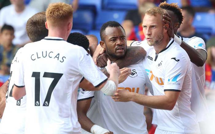 Swansea City’s Jordan Ayew (centre) celebrates with teammates after scoring the second goal. Picture: @SwansOfficial/Twitter.