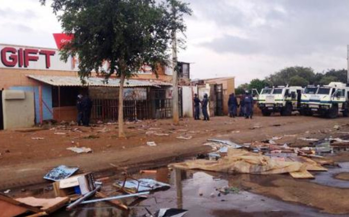 Police Nyalas outside a shop that was looted in Bekkersdal. 25 October 2013. Picture: Govan Whittles/EWN"