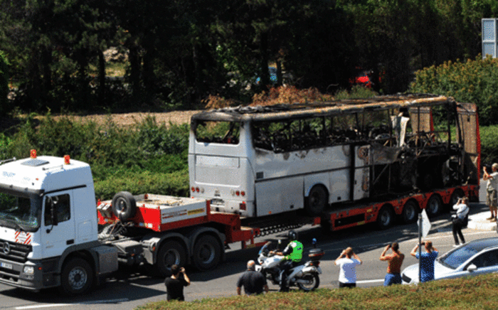 A truck carries the bus damaged by the suicide bomb blast which targeted a group of Israeli tourists at the airport in Bourgas, Bulgaria, on 19 July 2012. Picture: AFP