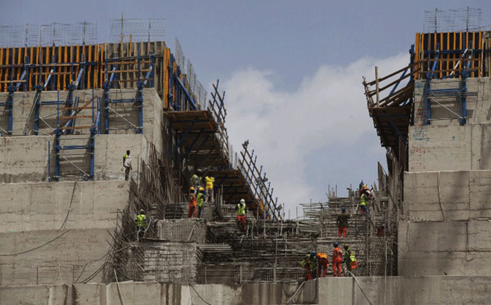 File: Ethiopian workers construct on 31 March, 2015 the Grand Renaissance Dam near the Sudanese-Ethiopian border. Ethiopia began diverting the Blue Nile in May 2013 to build the 6,000 megawatt dam, which will be Africa's largest when completed in 2017. Picture: AFP