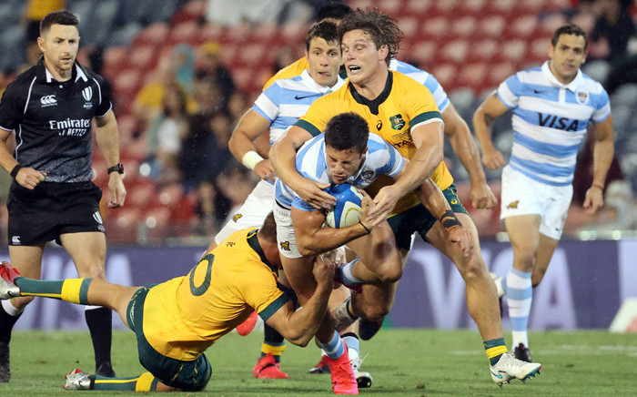 Australia's Reece Hodge (L) and Australia's captain Michael Hooper (R) tackle Argentina's Bautista Delguy (C) during the 2020 Tri Nations rugby match at McDonald Jones Stadium in Newcastle on 21 November 2020. Picture: AFP