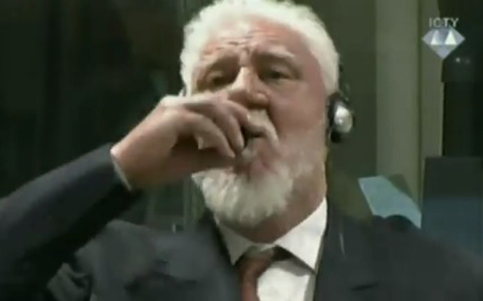 A screengrab purporting to show wartime commander of Bosnian Croat forces Slobodan Praljak drinking what he said was poison in court.