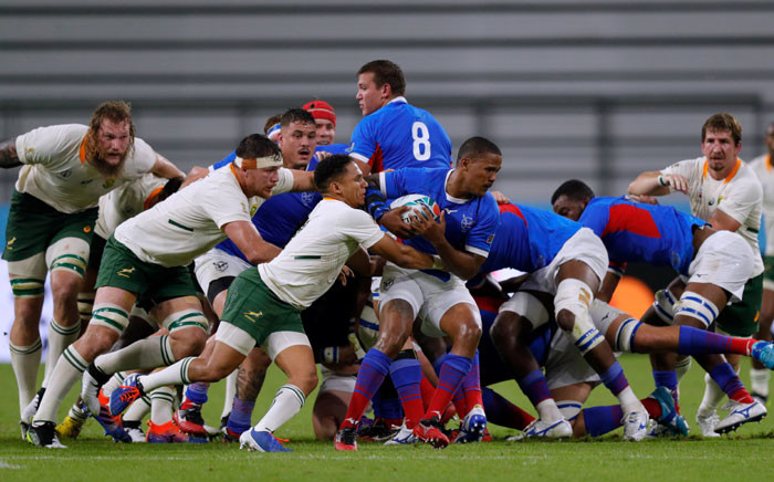 Namibia's scrum-half Eugene Jantjies (C-R) is atckled by South Africa's scrum-half Hershel Jantjies (C-L) during the Japan 2019 Rugby World Cup Pool B match between South Africa and Namibia at the City of Toyota Stadium in Toyota City on 28 September 2019.