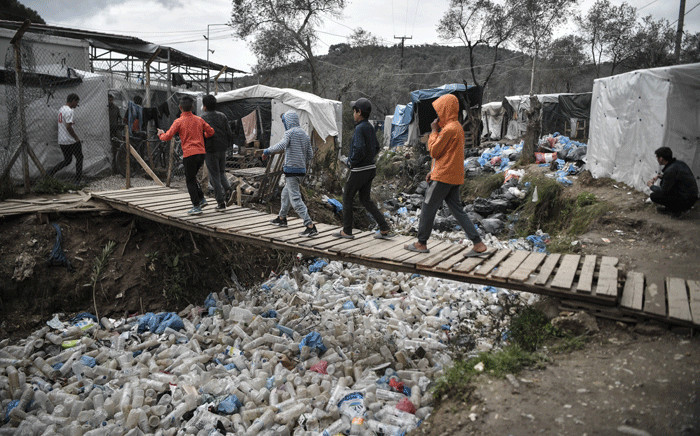 FILE: Children walk over a bridge in the Moria migrant camp on the Greek Aegean island of Lesbos on March 5, 2020. Picture: AFP