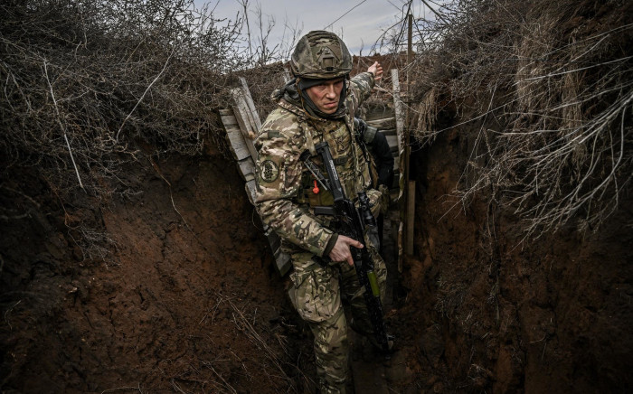 Ukrainian troops patrol at the frontline outside the town of Novoluhanske, eastern Ukraine, on 19 February 2022. Picture: Aris Messinis/AFP