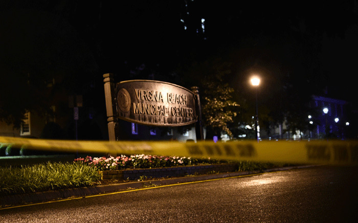 A police tape blocks the road to access the Virginia Beach municipal centre, the site of a mass shooting, in Virginia Beach, Virginia in the late hours of May 31, 2019. A municipal employee sprayed gunfire "indiscriminately" in a government building complex on Friday in the US state of Virginia, police said, killing 12 people and wounding four in the latest mass shooting to rock the country. Picture: AFP.