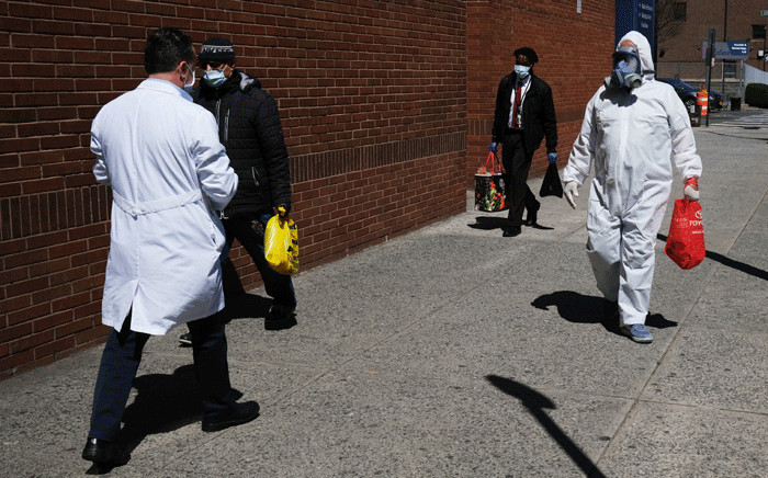 A man wearing a hazmat suit walks outside of Montefiore Medical Center on 6 April 2020 in the Bronx borough of New York City. Hospitals in New York City, which has been especially hard hit by the coronavirus, are facing shortages of beds, ventilators and protective equipment for medical staff. Picture: AFP.
