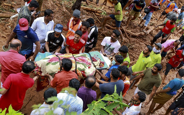 Rescue workers shift a body from the debris left after a landslide at Kavalappara in Malappuram district of the south Indian state of Kerala on 11 August 2019. Picture: AFP