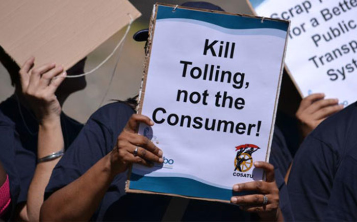 FILE PICTURE: A protester holds up a placard voicing their message against e-tolling. Picture: Aletta Gardner/EWN
