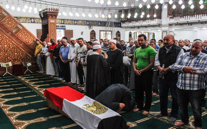 Egyptians pray before the coffin of police officer Ahmed Fayez during his funeral inside a mosque in the capital Cairo's western suburb of Sixth of October on 21 October 2017. Picture: AFP.