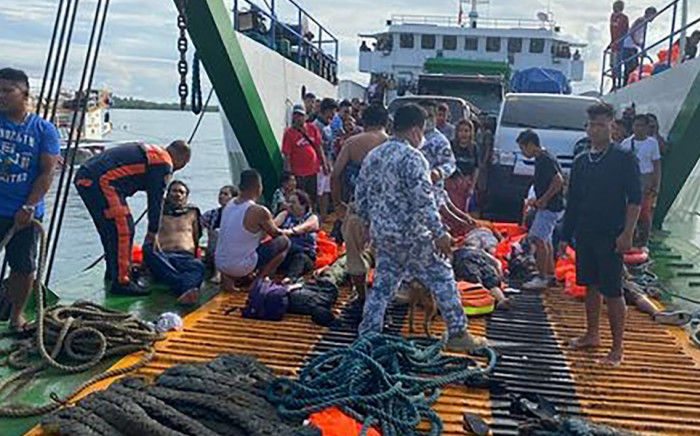This handout photo taken and released on May 23, 2022 from the Philippine Coastguard shows rescued ferry passengers sitting onboard another ferry off Real town, Quezon province. Picture: Handout / Philippine Coastguard / AFP