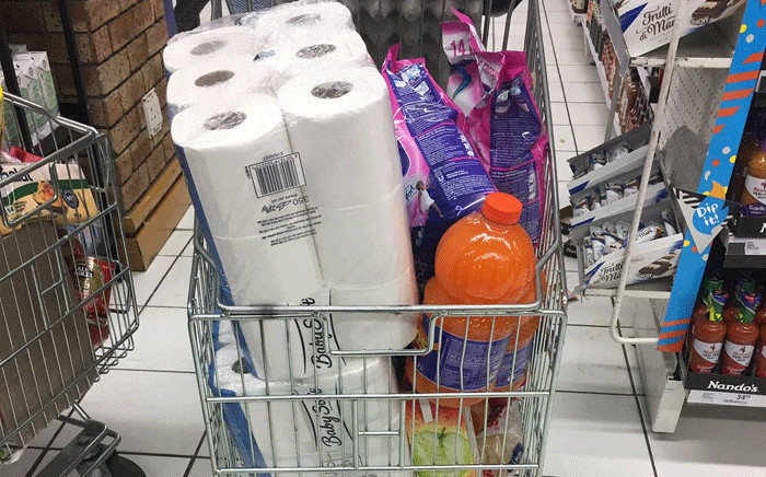 A shopper fills her trolley with items as she rushes to buy more items during Black Friday in Sandton City on 23 November 2018. Picture: EWN
