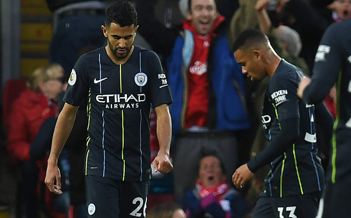 Manchester City's Algerian midfielder Riyad Mahrez (L) passes Manchester City's Brazilian striker Gabriel Jesus as he reacts after failing to convert a penalty during the English Premier League football match between Liverpool and Manchester City at Anfield in Liverpool, north west England on 7 October 2018. Picture: AFP