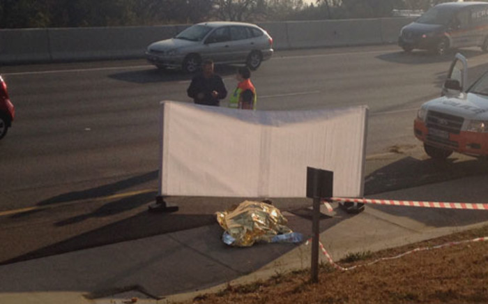 The body of a taxi accident victim lies behind a screen on the N1 highway in Johannesburg on 24 August 2012. Picture: Jacob Moshokoa/EWN
