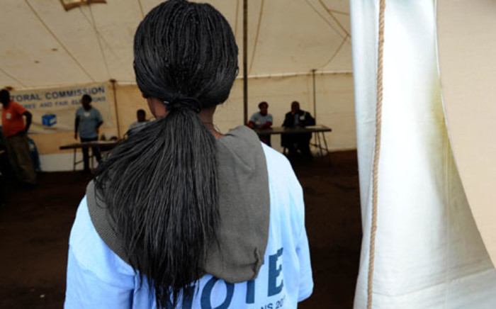 An Independent Electoral Commission officer stands at the entrance of a voting station. Picture: Werner Beukes/SAPA